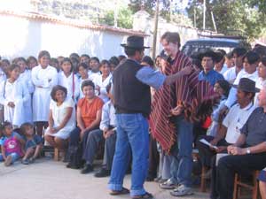 Brendan Sherar, Vice-President of BiblioWorks, receives a traditional poncho from the town mayor.