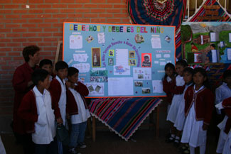 yamp.1year.kidswithposter 4th grade class presenting their educational poster about children