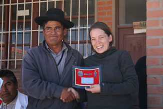 Latin America Project Coordinator with the recognition plaque given to her by the Yamaparaez mayor.